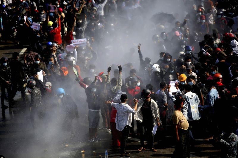 Protesters are sprayed with water fired from a police truck's water cannon in Naypyitaw, Myanmar on February 8, 2021. Tension in the confrontations between the authorities and demonstrators against last week's coup in Myanmar boiled over Monday, as police fired a water cannon at peaceful protesters in the capital Naypyitaw. (AP/PTI Photo)