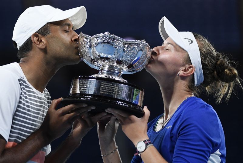 Melbourne: Rajeev Ram of the US and Barbora Krejcikova of the Czech Republic kiss their trophy after defeating Australia's Samantha Stosur and Matthew Ebden in the mixed doubles final at the Australian Open tennis championship in Melbourne, Australia, Saturday, Feb. 20, 2021. AP/PTI