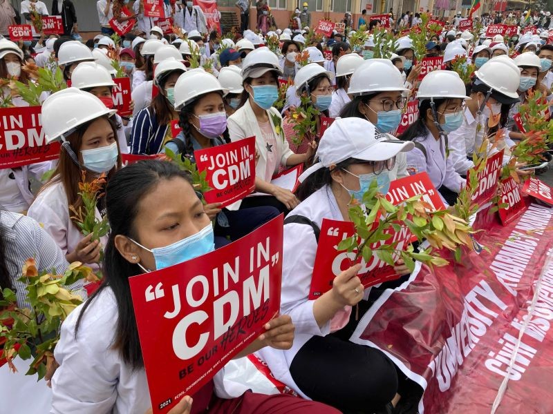Medical students wearing face masks hold placards as they gather during an anti-coup protest in Mandalay, Myanmar on February 21, 2021. Riot police in Myanmar shot dead at least a few anti-coup protesters and injured several others on Saturday, as security forces increased pressure on popular revolt against the military takeover. CDM stands for "civil disobedience movement".  (AP/PTI Photo)