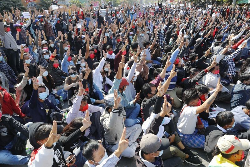 Protesters flash the three-fingered salute, a symbol of resistance, during a protest in Mandalay, Myanmar on February 9, 2021. Protesters continued to gather Tuesday morning in major cities breaching Myanmar's new military rulers ban of public gathering of five or more issued on Monday intended to crack down on peaceful public protests opposing their takeover. (AP/PTI  Photo)