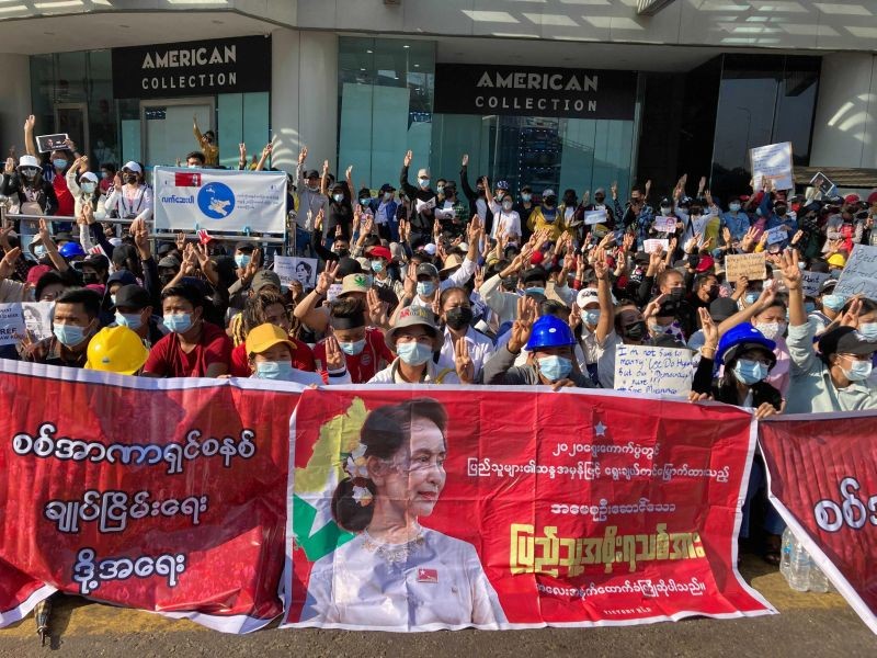Demonstrators display three-fingered salute, a symbol of resistance at an intersection in Yangon, Myanmar on February 10, 2021. Protesters continued to gather Wednesday morning in Yangon breaching Myanmar's new military rulers' decrees that effectively banned peaceful public protests in the country's two biggest cities. AP/PTI Photo)