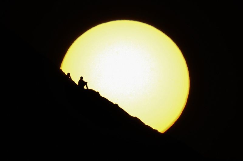 Phoenix : People watch the sunset from a peak at Papago Park, Friday, Feb. 19, 2021, in Phoenix. AP/PTI