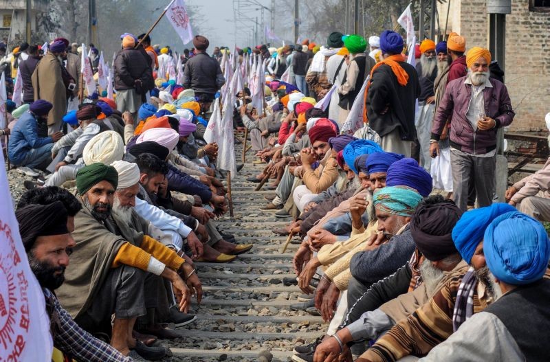 Members of various farmer organisations block a railway track during a four-hour 'rail roko' demonstration across the country, called by Samyukta Kisan Morcha (SKM), as part of their agitation against Centre's farm reform laws, in Amritsar district on February 18, 2021. (PTI Photo)