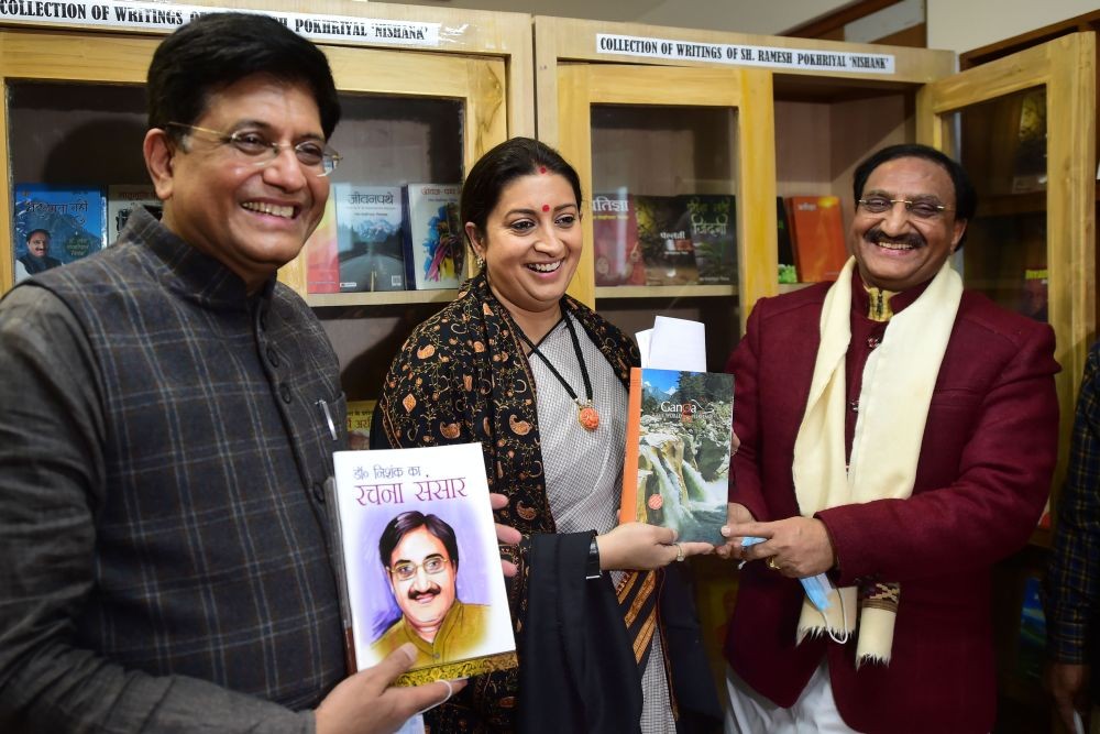New Delhi: HRD Minister Ramesh Pokhriyal unviels a book dedicated to his writings in the presence of Railways Minister Piyush Goyal (L) and Minister of Textiles and Women and Child Development Smriti Irani (C) in New Delhi, Thursday, Feb. 11, 2021. (PTI Photo/ Kamal Kishore