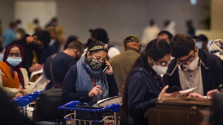 Passengers wait in the arrival area after landing of a flight from United Kingdom at the Chhatrapati Shivaji Maharaj International Airport, in Mumbai. (PTI File)