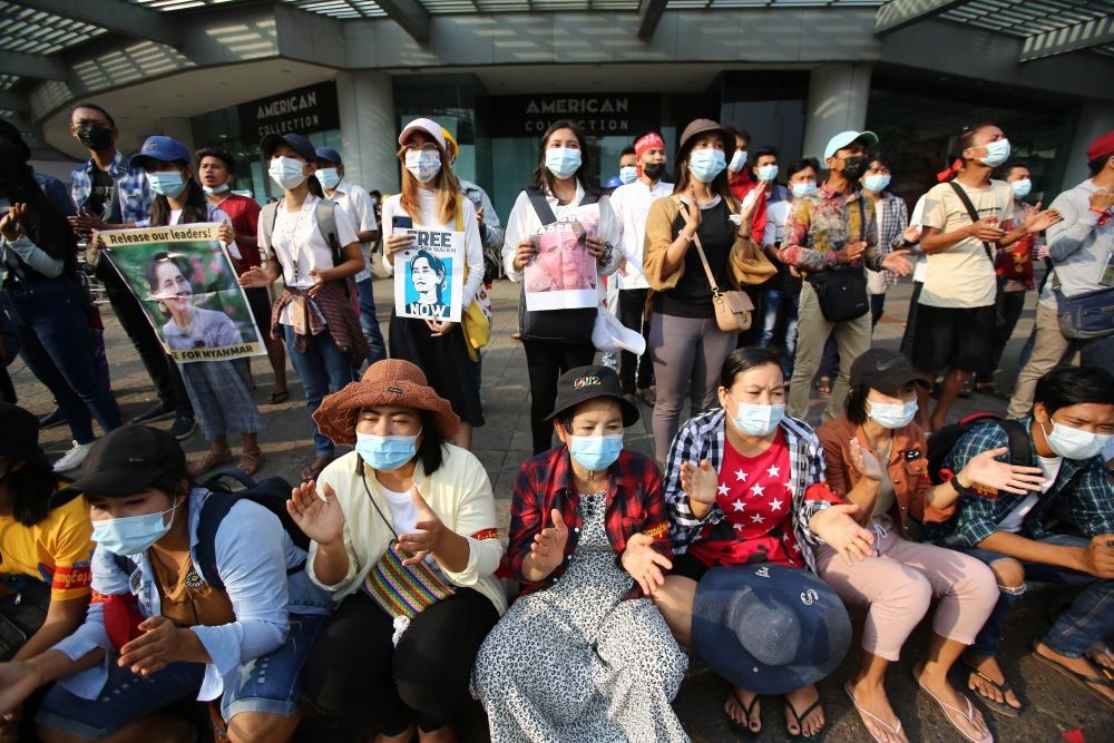 Yangon : Anti-coup protesters hold images of deposed Myanmar leader Aung San Suu Kyi as they gather outside the Hledan Centre in Yangon, Myanmar Friday, Feb. 19, 2021. The daily protests campaigning for civil disobedience in Myanmar are increasingly focusing on businesses and government institutions that sustain the economy.  AP/PTI
