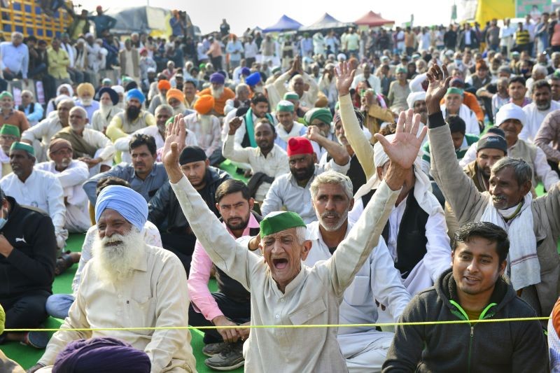 Farmers raise slogans during the ongoing protest against the new farm laws, at Ghazipur Border in New Delhi on February 8. (PTI Photo)
