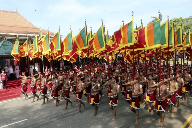 Sri Lankan soldiers hold national flags and march in a parade during the 73rd Independence Day ceremony in Colombo, Sri Lanka on February 4, 2021. (AP/PTI Photo)