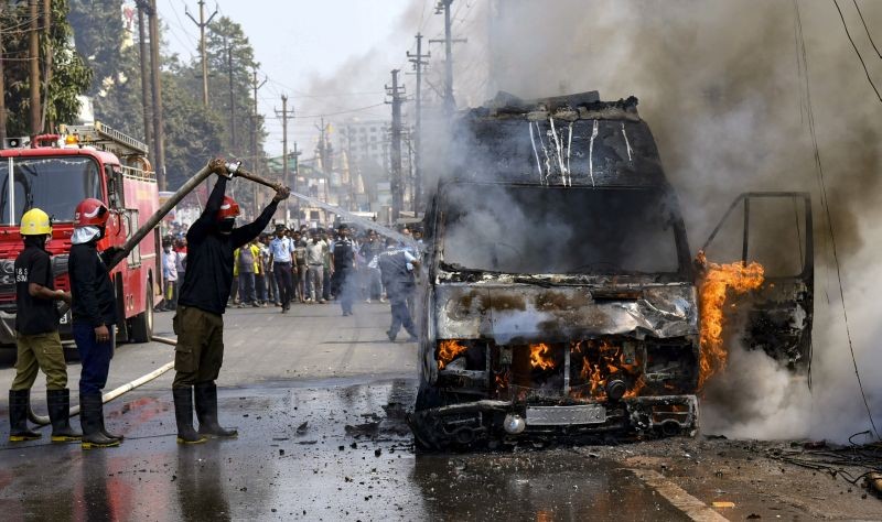 Firefighters attempt to douse fire that broke out in an ambulance, at Jatia in Guwahati on February 23, 2021. The ambulance was transporting a patient from Ganeshguri area to Kahilipara. (PTI Photo)