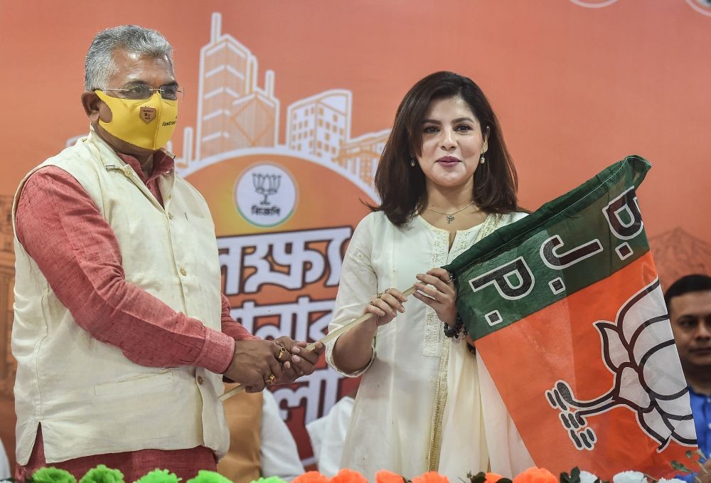 Kolkata: State BJP President Dilip Ghosh hands over the party flag to Tollywood actor Payel Sarkar as she joins BJP at State BJP election office in Kolkata, Thursday, Feb 25, 2021. (PTI Photo/Swapan Mahapatra)