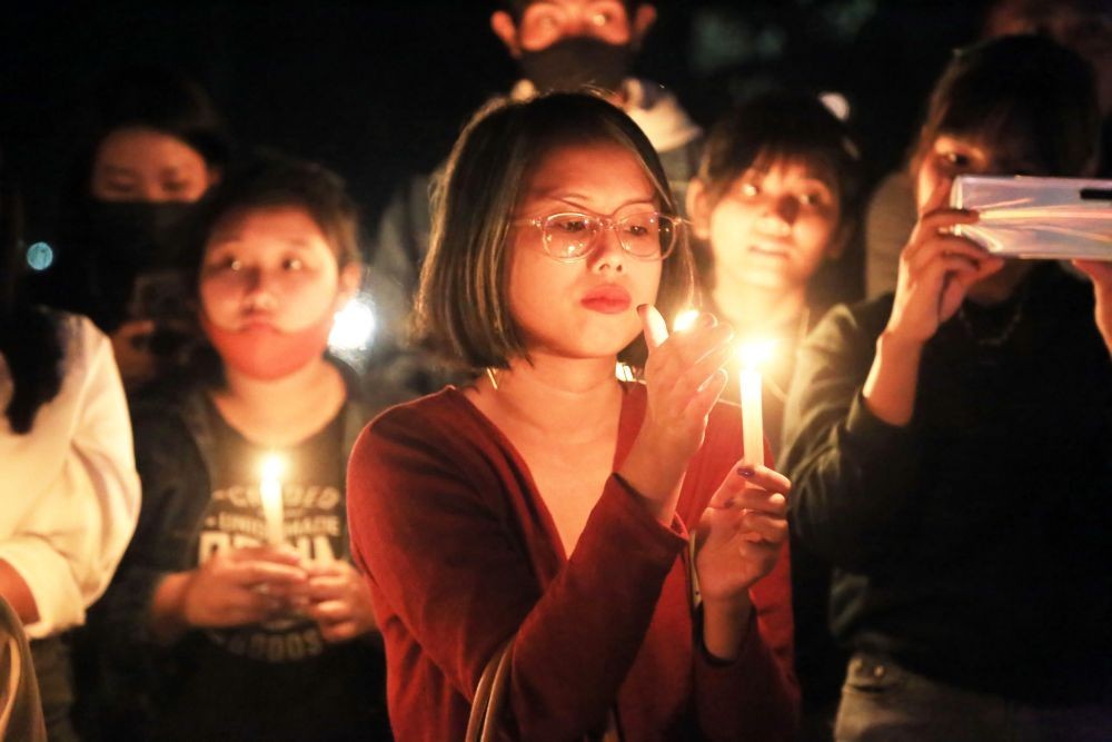 IN SOLIDARITY: A woman holds a candle during the candlelight vigil held by citizens of Dimapur on March 7 in solidarity with the people in Myanmar who are protesting against military coup in the country.  Hundreds attended the event held at The Garden premise in Supermarket area, Dimapur on Sunday evening. (Morung Photo by Soreishim Mahong)