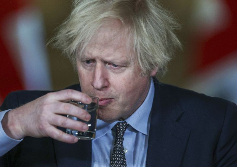 Britain's Prime Minister Boris Johnson takes a drink during a news conference at 10 Downing Street, on the first anniversary of Britain's coronavirus lockdown, in London on March 23, 2021. The day is being called a national day of reflection to mark the anniversary of Britain's first coronavirus disease (COVID-19) lockdown. (AP/PTI Photo)