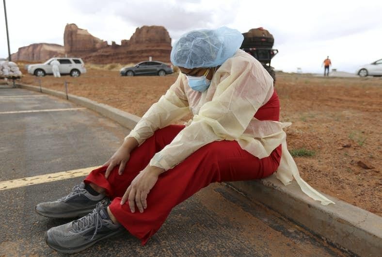 Denise Begaye, an X-ray technician with the Monument Valley Health Center in Oljato-Monument Valley taking a break from her shift on Thursday, April 16, 2020. AP Photo