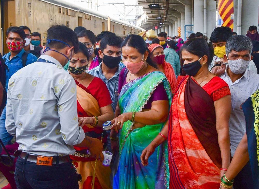 Mumbai: A health worker conducts the screening of passengers after they arrived via a train, at Dadar Station in Mumbai, Sunday, March 14, 2021. (PTI Photo)