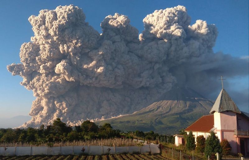 Mount Sinabung spews volcanic material during an eruption in Karo, North Sumatra, Indonesia on March 2, 2021. The 2,600-metre (8,530-feet) volcano is among more than 120 active volcanoes in Indonesia, which is prone to seismic upheaval due to its location on the Pacific "Ring of Fire," an arc of volcanoes and fault lines encircling the Pacific Basin. (AP/PTI Photo)