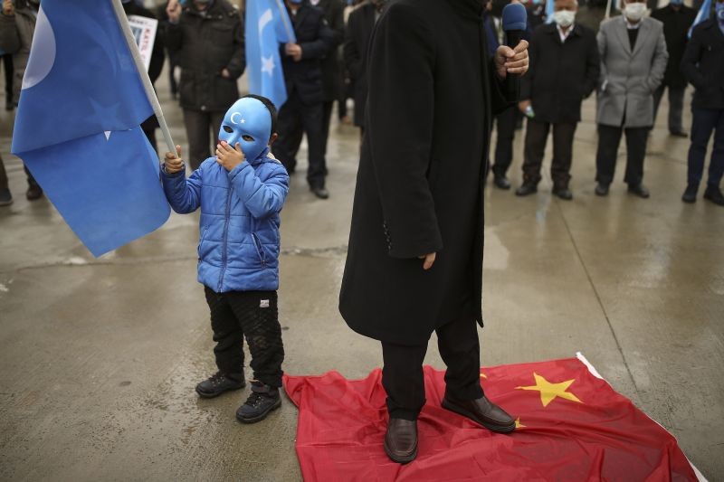 Protesters from the Uyghur community living in Turkey step on a China's flag during a protest against the visit of China's Foreign Minister Wang Yi to Turkey, in Istanbul on March 25, 2021. Hundreds of Uyghurs staged protests in Istanbul and the capital Ankara, denouncing Wang Yi's visit to Turkey and demanding that the Turkish government take a stronger stance against human rights abuses in China's far-western Xinjiang region. (AP/PTI Photo)