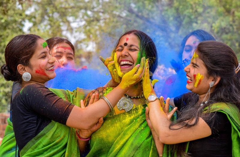 Nadia: Women smear colours at each other during Holi celebrations in Nadia district, Saturday, March 20, 2021. (PTI Photo)