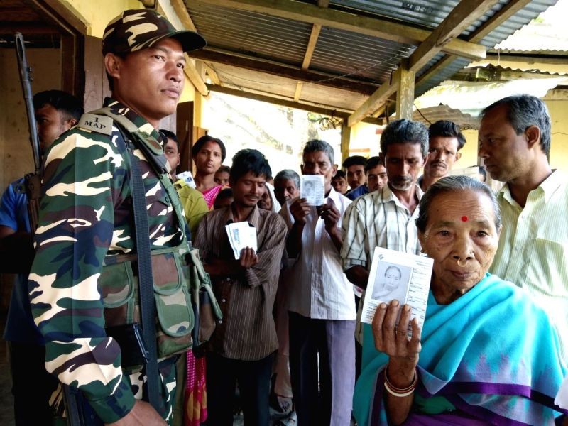 An elderly woman shows her voter's ID card at a polling station during the third phase of Lok Sabha polls, in Tripura's Khowai, on April 23, 2019. (IANS File Photo)