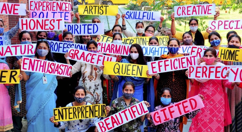 Patiala: Teachers hold placards during an awareness programme ahead of International Women's Day, in Patiala, Saturday, March 06, 2021. (PTI Photo)