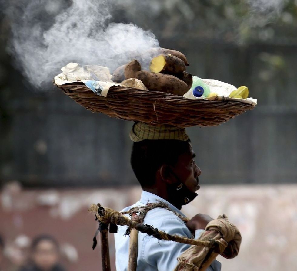 New Delhi: A vendor walks on a street looking for customers in New Delhi, Friday, March 12, 2021. (PTI Photo/Atul Yadav)