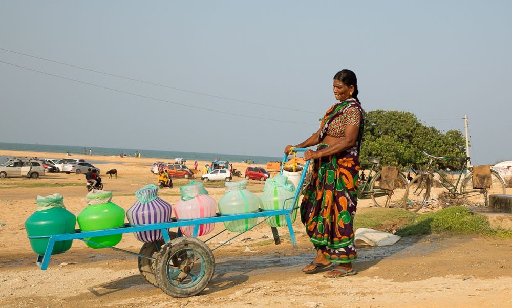 Tirunelveli: A woman pushes a cart with plastic containers, filled with water, on the way to her house after collecting it from a public well as seen on the eve of World Water Day, in Tirunelveli, Sunday, March 21, 2021. (PTI Photo)