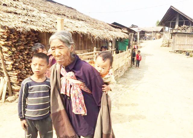 A woman carries her grandchild in Langnok village under Noklak district. (Photo Courtesy: Nungshitemjen Jamir)