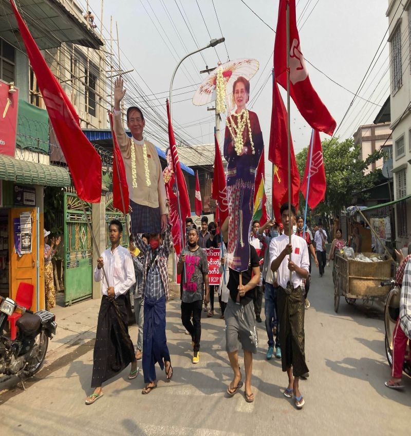 Protesters holds a portrait of deposed Myanmar leader Aung San Suu Kyi, right, on a main road during a demonstration in Mandalay, Myanmar, on March 8, 2021. Large protests have occurred daily across many cities and towns in Myanmar. (AP/PTI Photo)