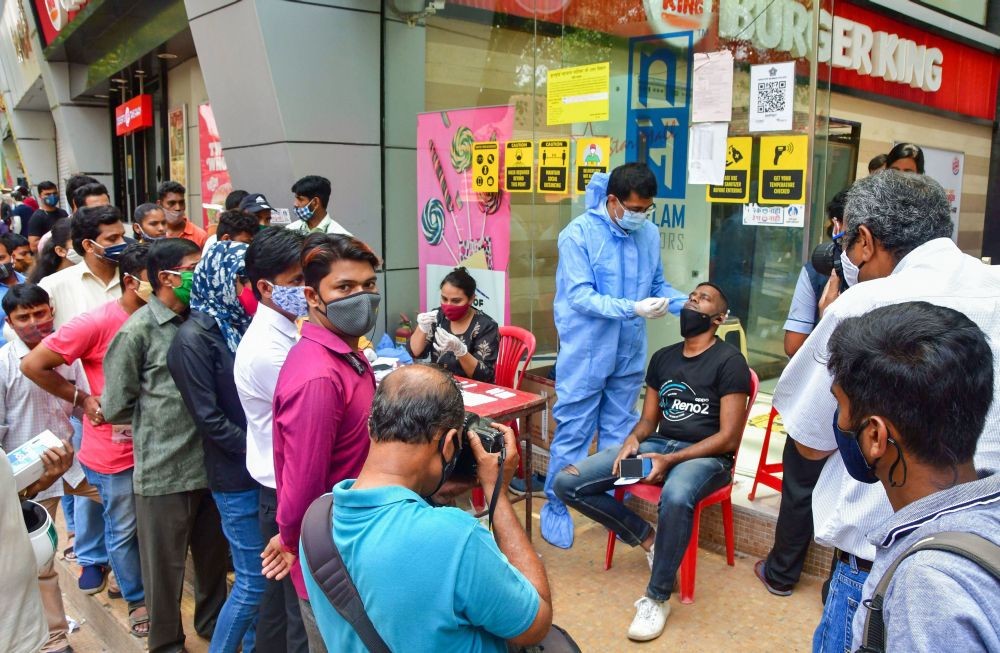 Mumbai: A health worker takes swab samples of visitors for COVI-19 tests, at a mall at Dadar in Mumbai, Tuesday, March 23, 2021. (PTI Photo)