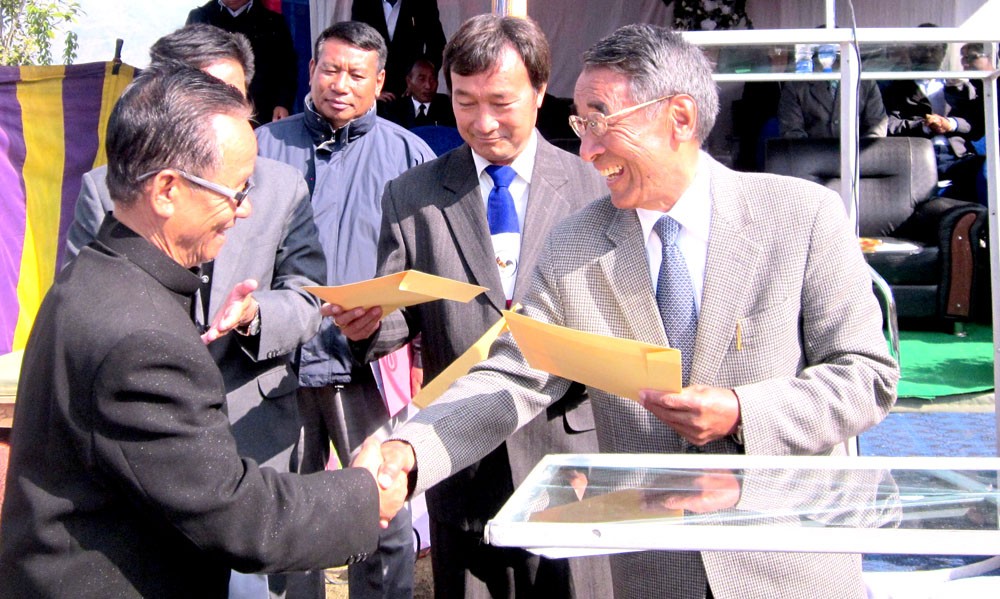 NPF president Dr. Shürhozelie Liezietsu (right) is seen here handing over the NPF party’s ticket to a candidate at the NPF ticket-distribution ceremony on January 7 at Senapati in Manipur. (Morung Photo/ Chizokho Vero)