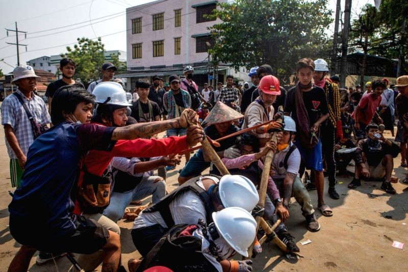 Demonstrators use a self-made catapult during clashes with police at a demonstration against the military coup and the detention of civilian leaders. (IANS Photo)