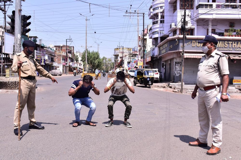 Jabalpur: Police punish commuters for flouting lockdown norms, imposed by authorities to curb the recent surge in coronavirus cases in Jabalpur, Sunday, March 21, 2021. (PTI Photo)