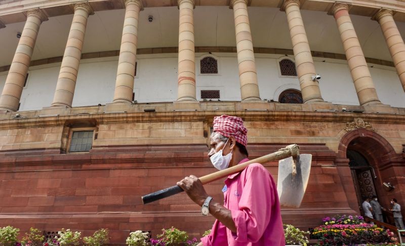 A worker walks in the premises of Parliament complex on March 17, 2021. (PTI Photo)