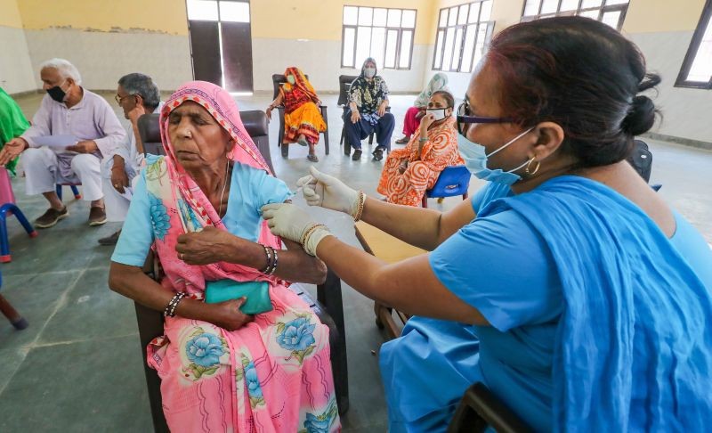 A medic prepares to administer COVID-19 vaccine to a senior citizen during a countrywide inoculation drive, in Gurugram on March 26. (PTI Photo)