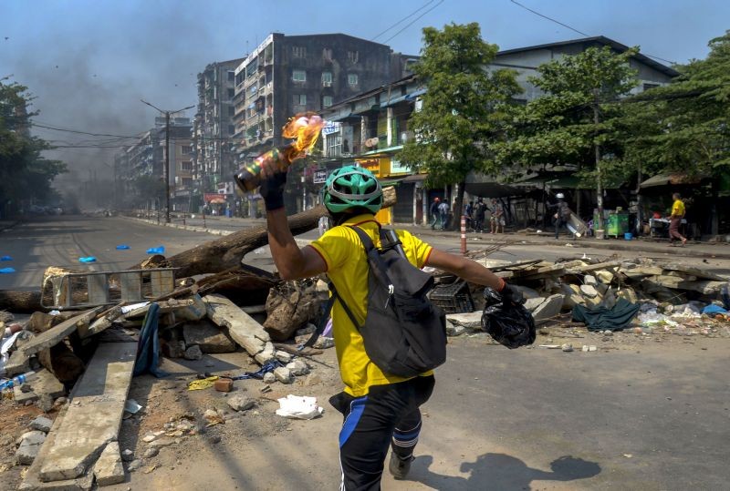 An anti-coup protester throws a molotov cocktail towards police as they move towards the protest area in Yangon, Myanmar on March 17. (AP/PTI Photo)
