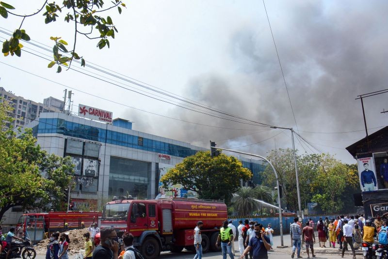 Firefighters attempt to douse a blaze at Dream Mall, affecting patients admitted in the nearby COVID-19 dedicated Sunrise Hospital, in Mumbai on March 26, 2021. (PTI Photo)