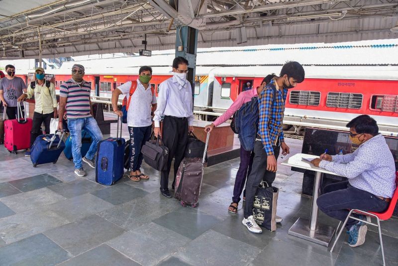 Bikaner: A health worker receives details of passengers arriving from Maharashtra for COVID-19 tests upon their arrival at the Bikaner Railway Station, Saturday, March 20, 2021. (PTI Photo)