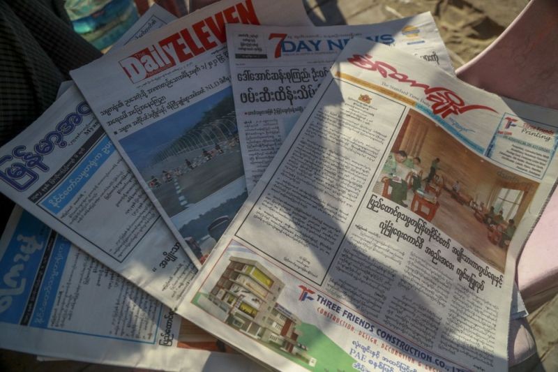 In this Feb. 2, 2021, file photo, local newspapers are displayed in a newspaper stall in Yangon, Myanmar. The front page of Standard Time Daily, right, reads "Meeting of National Defence and Security Council held in Naypyitaw." Myanmar’s military-controlled government is seeking to suppressing media coverage of protests against their seizure of power as journalists and ordinary citizens strive to keep people inside and outside of the country informed about what is happening. (AP File Photo)