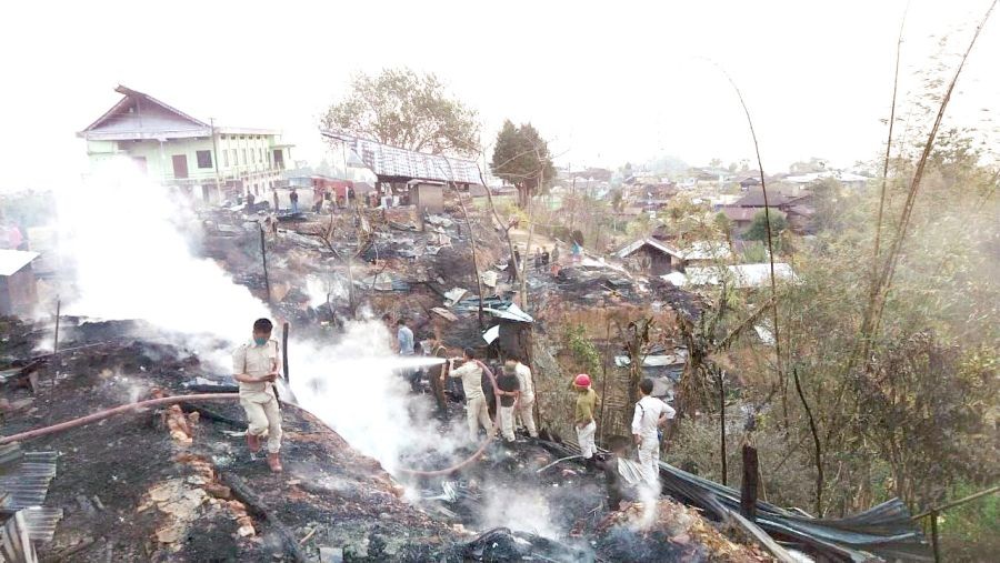 Firefighters along with others are seen clearing the debris at Longkong fire incident site on March 25. (Photo courtesy: Mokokchung Police)