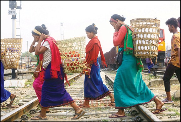 A group of women cross the railway track on their way back home after selling local vegetables in Dimapur. (Morung Photo by Soreishim Mahong)
