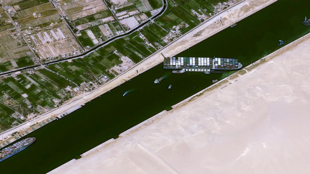 This satellite image from Cnes2021, Distribution Airbus DS, shows the cargo ship MV Ever Given stuck in the Suez Canal near Suez, Egypt, Thursday, March 25, 2021. The skyscraper-sized cargo ship wedged across Egypt's Suez Canal further imperiled global shipping Thursday as at least 150 other vessels needing to pass through the crucial waterway idled waiting for the obstruction to clear, authorities said. (Cnes2021, Distribution Airbus DS via AP)