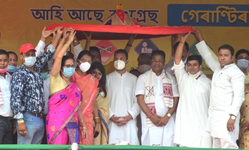 Biswanath: Congress leader Rahul Gandhi being presented an 'Assamese Japi' during an election campaign rally in support of party candidate from Gohpur seat Ripun Bora ahead of the Assam Assembly polls, at Gohpur in Biswanath District of Assam, Saturday, March 20, 2021. (PTI Photo)