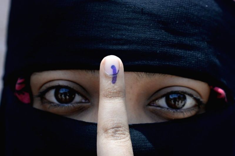 A first time voter shows her inked finger after casting her vote . (IANS Photo)