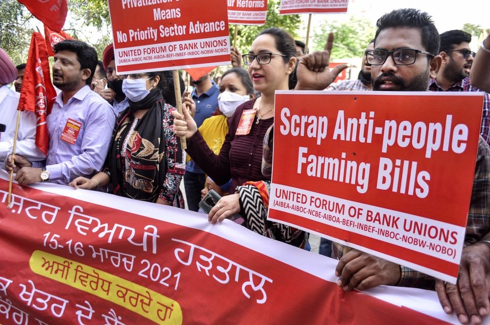 Patiala: Bank employees display banners and placards at a protest during a two-day nationwide banks' strike against the privatisation of Public Sector Banks and retrograde banking reforms, in Patiala, Monday, March 15, 2021. (PTI Photo)