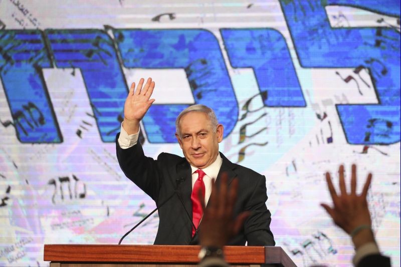 Israeli Prime Minister Benjamin Netanyahu waves to his supporters after the first exit poll results for the Israeli parliamentary elections at his Likud party's headquarters in Jerusalem on March. 24, 2021. (AP/PTI Photo)