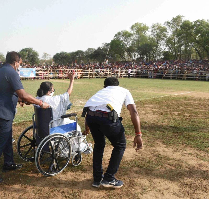 West Bengal CM and TMC supremo Mamata Banerjee, sitting on a wheel-chair, arrives to address an election campaign rally ahead of state assembly polls, in Bankura on March 16. (PTI Photo)