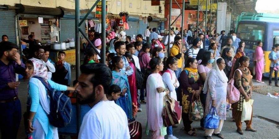 Commuters not adhering to COVID-19 norms wait at a bus stop during the ongoing coronavirus pandemic in Patiala Saturday March 13 2021. (Photo | PTI)