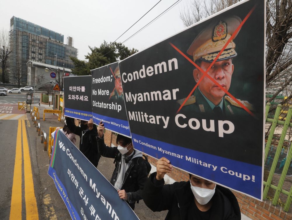 Seoul: Myanmar nationals living in South Korea hold up defaced images of Myanmar's Commander-in-Chief Senior Gen. Min Aung Hlaing during a rally against Myanmar's military coup in front of Myanmar embassy in Seoul, South Korea, Saturday, March 13, 2021. AP/PTI