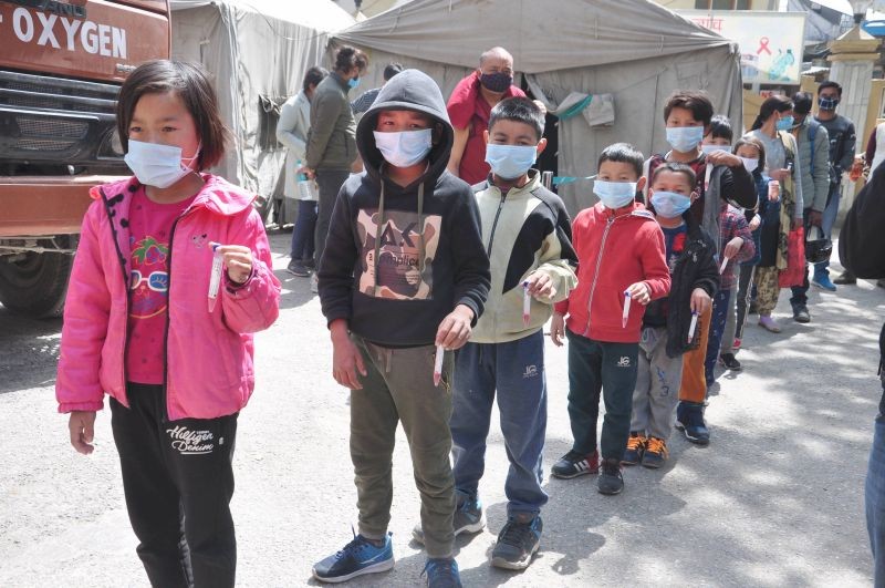 Kullu: Children stand in a queue to give samples for COVID -19 test in Kullu, Friday, March 19, 2021. (PTI Photo)