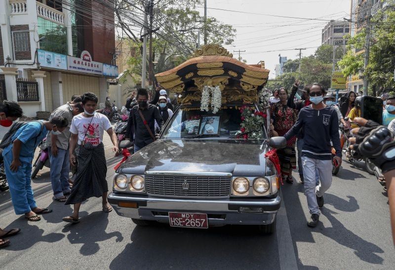 Mourners pay their respect as a hearse carrying the coffin of Kyal Sin is driven in Mandalay, Myanmar, Thursday, March 4, 2021. Kyal Sin was shot in the head by Myanmar security forces during an anti-coup protest rally she was attending on March 3, 2021. (AP/PTI Photo)