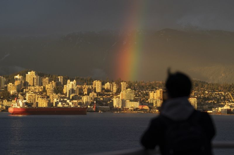 Vancouver: A man is silhouetted in front of a rainbow in downtown Vancouver, British Columbia, Thursday, March 18, 2021. AP/PTI(